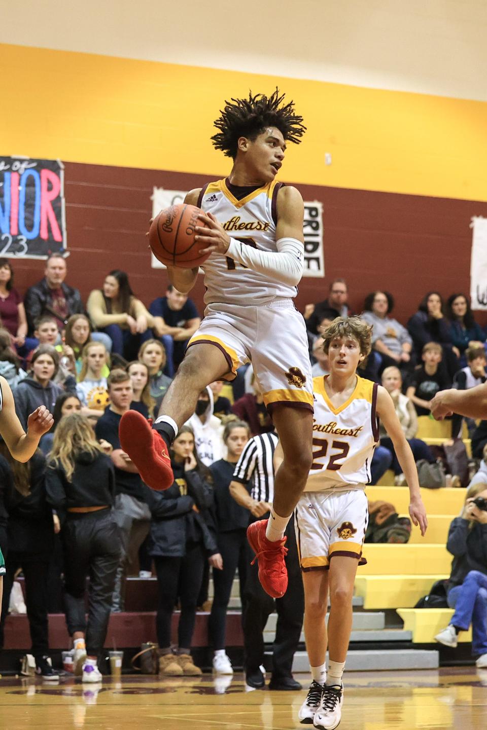 Southeast senior Brandon Clint leaps up to pull down a rebound during Friday night’s game against Mogadore.