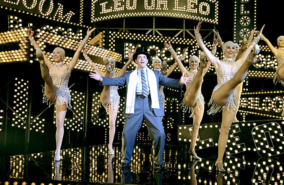 matthew broderick in a top hat surrounded by dancer in pearls as leo bloom in the producers