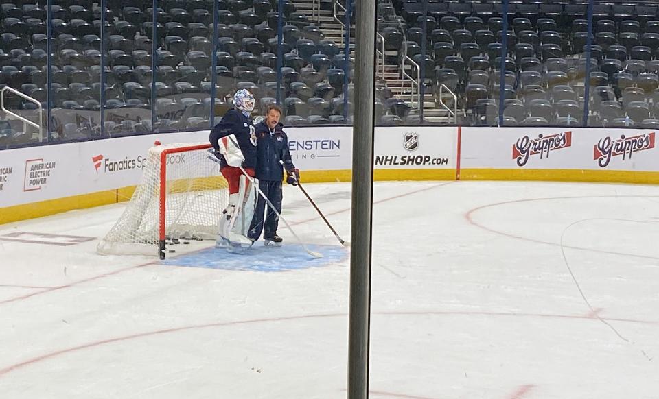 Oct 14, 2024; Columbus, Ohio, USA; Guy Gaudreau talks to goaltender Elvis Merzļikins during morning practice in Nationwide Arena. The Blue Jackets will host a ceremony remembering the lives of Johnny Gaudreau and his brother, Matthew, at 7 p.m. at the home opener. Puck drop is set for 7:13 p.m., a nod to Johnny Gaudreau's jersey number 13.