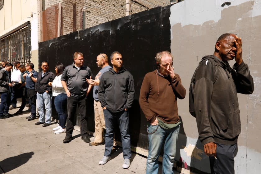 SAN FRANCISCO, CA - SEPTEMBER 11, 2019 - - Vishal Bathija, third from right, Garrett Hamilton, Kevin Skaife, Victoria Ramirez, Richard Fong and other participants of GLIDEÕs, ÒOfficer and a Mensch,Ó program, join the homeless in line for lunch at GLIDE Church in San Francisco on September 11, 2019. This task gave participants a first person experience of what the homeless do on a daily basis. The program tries to instill a greater understanding between law enforcement and the people of historically oppressed communities. Participants had a full immersion experience dealing with homelessness, addiction, mental illness, poverty and despair in the program. This training is intended to help leaders explore their understanding of the ways traditional government organizations and community-based providers can better ÒserveÓ challenged communities together to improve the quality of life for all of our citizens. (Genaro Molina / Los Angeles Times)