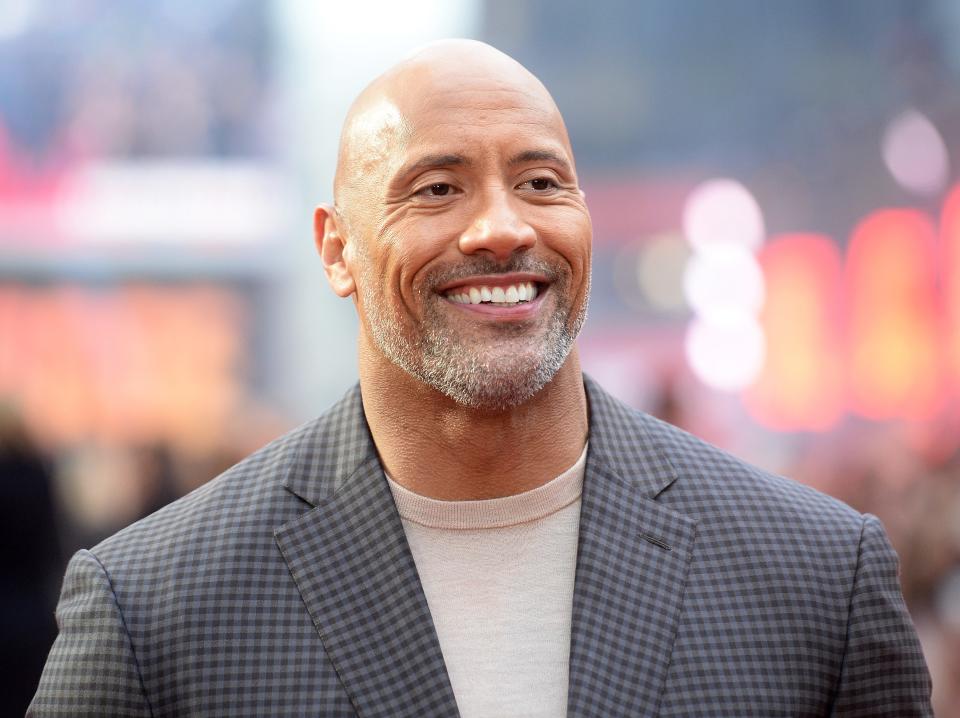 Dwayne smiling in a suit.