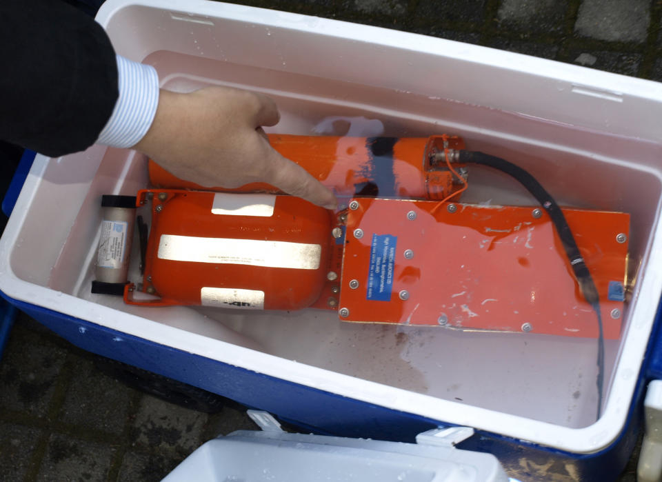 FILE - This file photo released by the Lebanese army, the black box of the Ethiopian Airlines jet that crashed off the the Lebanese coast on Jan. 25, 2010, is seen placed in a seawater container shortly after it was pulled out of the sea by Lebanese marine commandos, south of Beirut, Lebanon. Equipment inside two nearly indestructible boxes aboard the missing Malaysia Airlines plane recorded critical information that would help investigators reconstruct what went wrong. The flight data recorder and cockpit voice recorder have beacons that are sending out “pings” which searchers could track back to the main wreckage. But the batteries run out in about two weeks. (AP Photo/Lebanese Army, File)