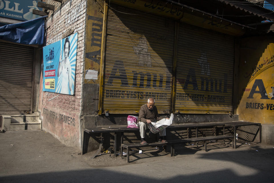 An elderly Kashmiri man reads a newspaper at a closed market during a strike called by separatists in Srinagar, Indian controlled Kashmir, Saturday, Oct. 31, 2020. Kashmir’s main separatist grouping called the strike to protest new land laws that India enacted on Tuesday, allowing any of its nationals to buy land in the region. Pro-India politicians in Kashmir have also criticized the laws and accused India of putting Kashmir’s land up for sale. The move exacerbates concerns of Kashmiris and rights groups who see such measures as a settler-colonial project to change the Muslim-majority region’s demography. (AP Photo/Mukhtar Khan)