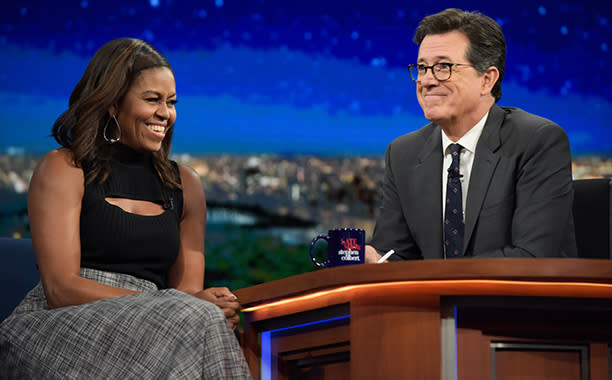 Michelle Obama showing off her “swagalicious” style in black tank with a cutout and wide-leg gray trousers on “The Late Show with Stephen Colbert.” 