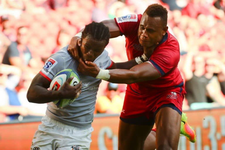 The Southern Kings' Yaw Penxe attempts to evade the tackle of the Queensland Reds' Eto Nabuli during their Super Rugby match, in Brisbane, on April 15, 2017