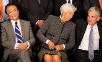 International Monetary Fund (IMF) Managing Director Christine Lagarde sits alongside Jerome Powell, Chairman of the U.S. Federal Reserve, and Japan's Minister of Finance Taro Aso as they pose for the official photo at the G20 Meeting of Finance Ministers in Buenos Aires, Argentina, July 21, 2018. REUTERS/Marcos Brindicci