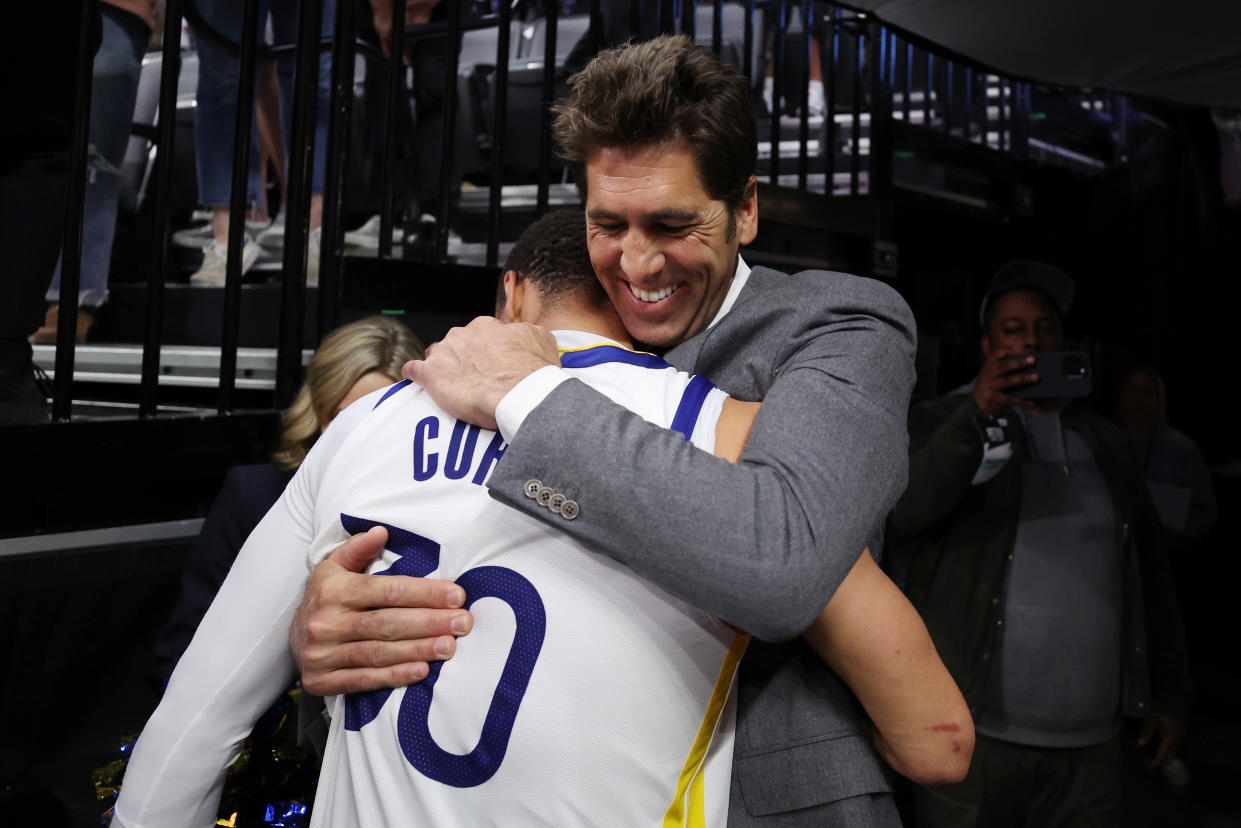 SACRAMENTO, CALIFORNIA - APRIL 30: Stephen Curry #30 of the Golden State Warriors hugs general manager Bob Myers after the Warriors defeated the Kings 120-100 in game seven of the Western Conference First Round Playoffs at Golden 1 Center on April 30, 2023 in Sacramento, California. NOTE TO USER: User expressly acknowledges and agrees that, by downloading and or using this photograph, User is consenting to the terms and conditions of the Getty Images License Agreement. (Photo by Ezra Shaw/Getty Images)