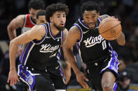 Sacramento Kings guard Malik Monk, right, races upcourt with guard Chris Duarte during the second half of the team's NBA basketball game against the Washington Wizards on Thursday, March 21, 2024, in Washington. (AP Photo/John McDonnell)