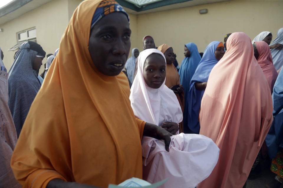 Parents are reunited with their daughters in Jangabe, Nigeria, Wednesday, March 3, 2021. More than 300 schoolgirls kidnapped last week in an attack on their school in northwest Nigeria have arrived in Jangabe after been freed on Tuesday. The Girls were abducted few days ago from Government Girls Secondary School in Jangabe in Zamfara state (AP Photo/Sunday Alamba)