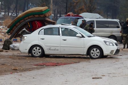 People ride a car with hanged mattresses at insurgent-held al-Rashideen in the province of Aleppo, Syria December 22, 2016. REUTERS/Ammar Abdullah