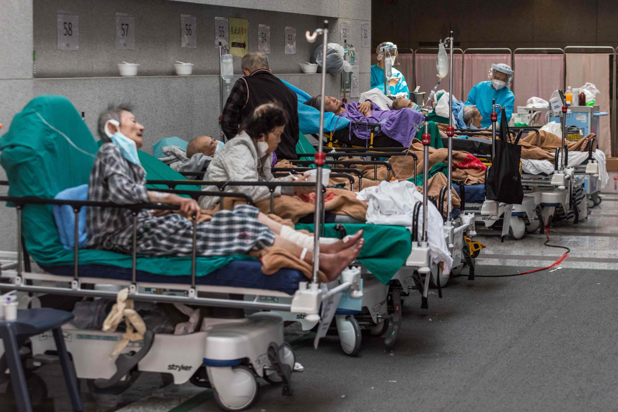 Health workers wearing personal protective equipment (PPE) treats patients in a holding area next to the accident and emergency department of Princess Margaret hospital in Hong Kong. (AFP via Getty Images)