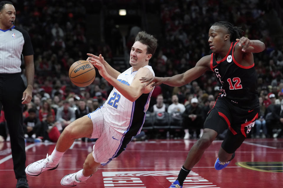 Orlando Magic forward Franz Wagner (22) loses control of the ball as Chicago Bulls guard Ayo Dosunmu (12) guards during the first half of an NBA basketball game in Chicago, Friday, Nov. 17, 2023. (AP Photo/Nam Y. Huh)