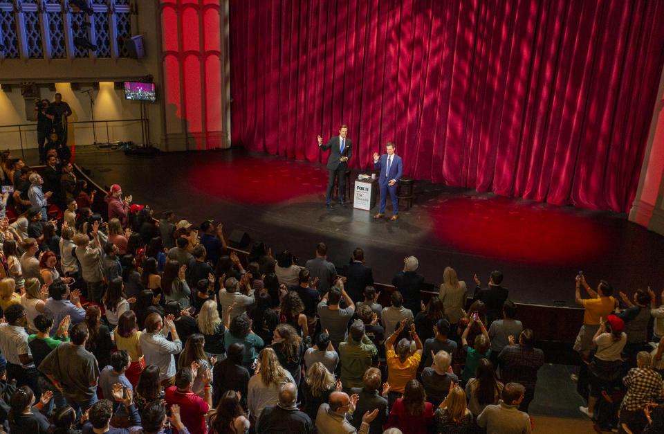 University of Southern California students stand up for Democratic presidential candidate and former South Bend Mayor Pete Buttigieg, right, and moderator Fox 11 anchor, Elex Michaelson, left, during the USC Dornsife Center for the Political Future town hall in Los Angeles Thursday, Feb. 20, 2020. (AP Photo/Damian Dovarganes)