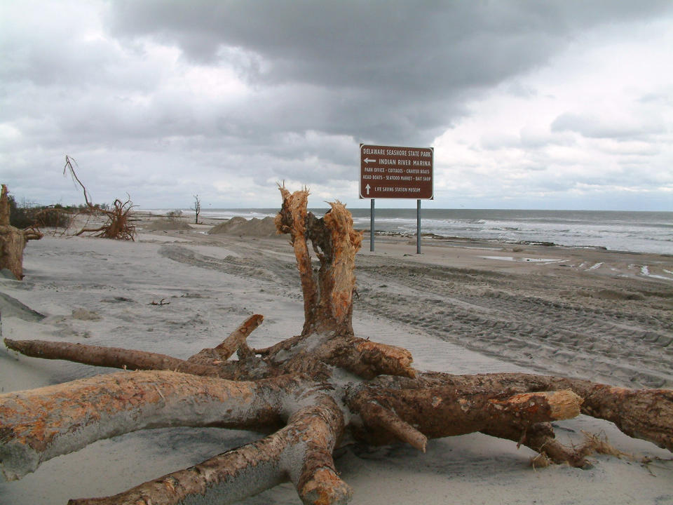 Debris litters the beach north of Indian River Inlet in southern Delaware after waves churned up by superstorm Sandy demolished hundreds of yards of beach dunes and left state Route 1, the major north-south coastal highway, covered in sand. (AP Photo/Randall Chase)