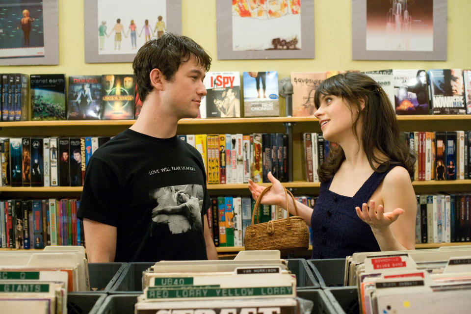 A couple stands in a record store