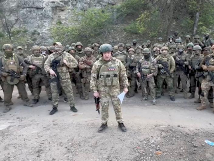 Founder of Wagner private mercenary group Yevgeny Prigozhin makes a statement as he stand next to Wagner fighters in an undisclosed location in the course of Russia-Ukraine conflict, in this still image taken from video released May 5, 2023.