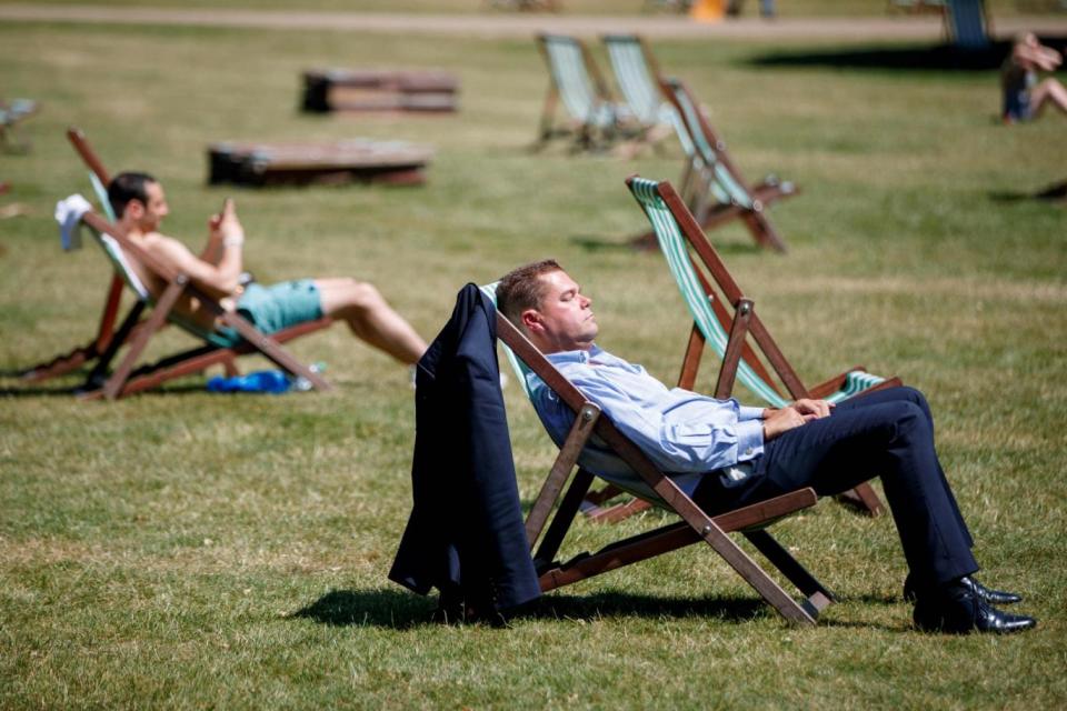 People enjoy the sunshine in St James's Park in London as temperatures are set to soar past 30C. (AFP/Getty Images)