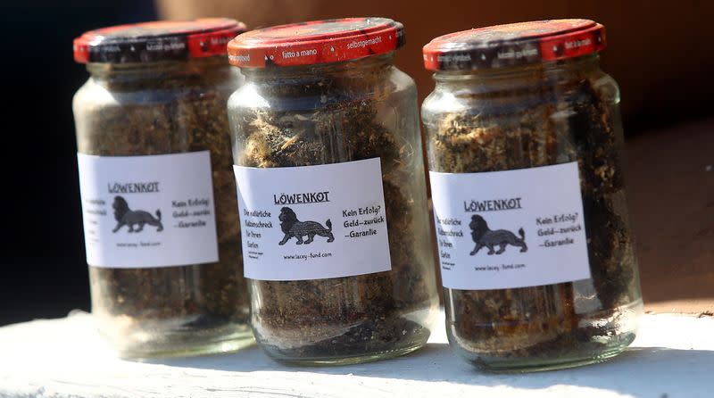 Jars of lion droppings are displayed in Munich