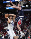 Dallas Mavericks forward Maxi Kleber (42) shoots as Houston Rockets guard Garrison Mathews defends during the first half of an NBA basketball game Friday, Jan. 7, 2022, in Houston. (AP Photo/Eric Christian Smith)