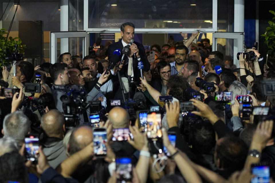 Greece's Prime Minister and leader of New Democracy Kyriakos Mitsotakis, center top, addresses supporters at the headquarters of his party in Athens, Greece, Sunday, May 21, 2023. The conservative party of Greek Prime Minister Kyriakos Mitsotakis has won a landslide election but without enough parliamentary seats to form a government. (AP Photo/Petros Giannakouris)