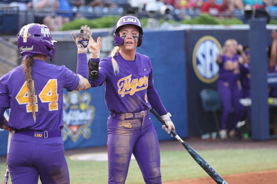 May 9, 2024; Auburn, AL, USA; LSU outfielder McKenzie Redoutey (4) celebrates with outfielder Ali Newland (44) after scoring a run against Tennessee in the quarterfinals of the SEC Softball Championship at Jane B. Moore Field. Mandatory Credit: John Reed-USA TODAY Sports
