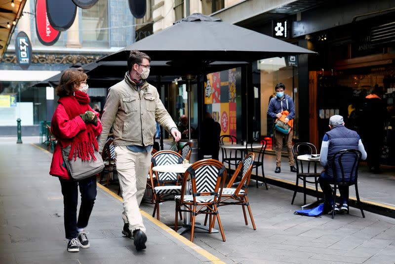 People walk past a cafe after the coronavirus disease (COVID-19) restrictions were eased for the state of Victoria, in Melbourne