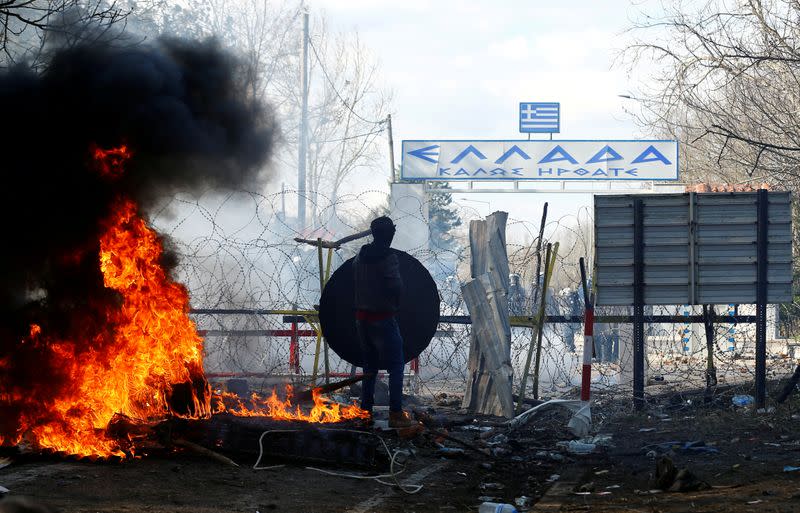 A migrants stands during clashes with Greek police, at the Turkey's Pazarkule border crossing with Greece's Kastanies, in Edirne
