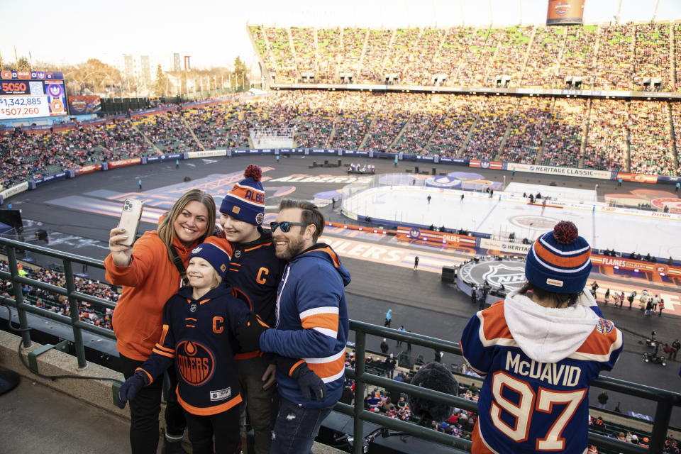 Fans arrive to watch the Calgary Flames and the Edmonton Oilers play in the NHL Heritage Classic outdoor hockey game in Edmonton, Alberta, Sunday, Oct. 29, 2023. (Jason Franson/The Canadian Press via AP)