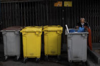 An elderly man searches through garbage bins in the southern neighbourhood of Vallecas, Madrid, Spain, Thursday, Oct. 1, 2020. Spain's government expects the economy to contract 11.2% this year, while the International Monetary Fund puts the drop at 12.8%, the highest rate among developed economies. (AP Photo/Bernat Armangue)