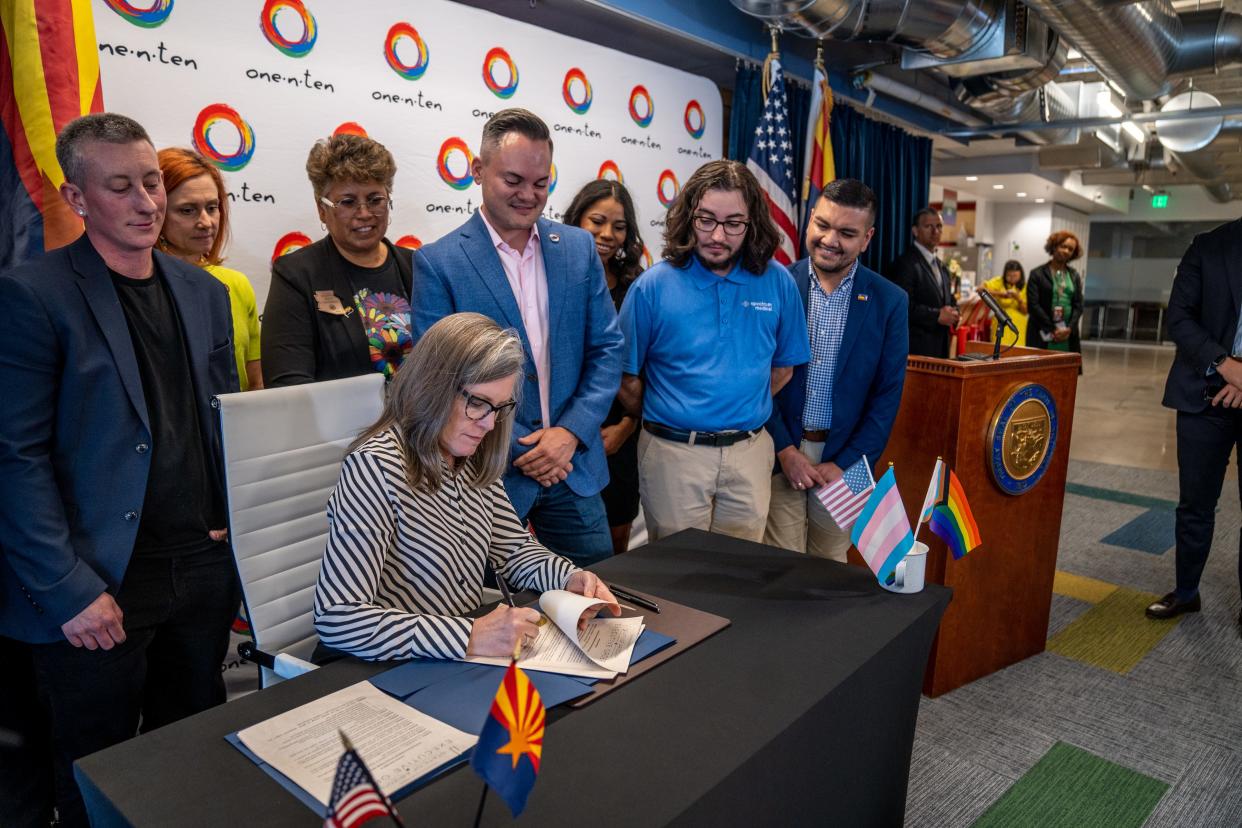 During a press conference at one-n-ten in Phoenix on June 27, 2023, Gov. Katie Hobbs signs executive orders aimed at protecting transgender medical care. The executive orders will expand protections for LGBTQ Arizonans by allowing state employees to access gender-affirming surgery and severing any official involvement with so-called conversion therapy.