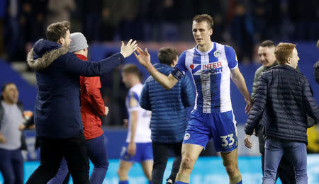 Soccer Football - FA Cup Fifth Round - Wigan Athletic vs Manchester City - DW Stadium, Wigan, Britain - February 19, 2018 Wigan Athletic’s Dan Burn celebrates with fans on the pitch after the match Action Images via Reuters/Carl Recine