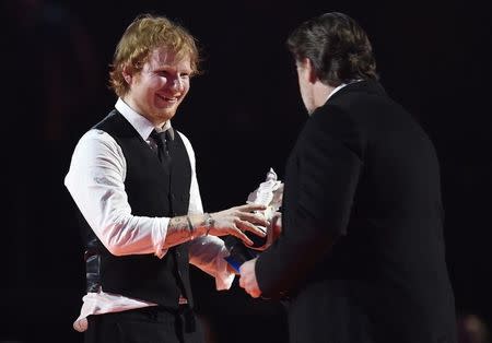 Ed Sheeran celebrates with Russell Crowe after receiving the British Album of the Year award at the BRIT music awards at the O2 Arena in Greenwich, London, February 25, 2015. REUTERS/Toby Melville