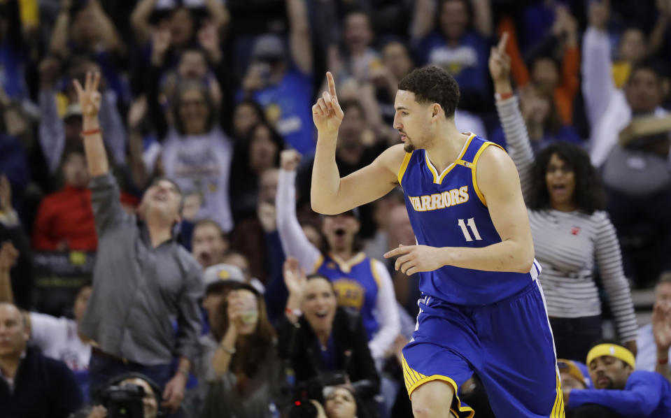 Golden State Warriors' Klay Thompson (11) celebrates after making a 3-point basket against the Memphis Grizzlies during the first half of an NBA basketball game Sunday, March 26, 2017, in Oakland, Calif. (AP Photo/Marcio Jose Sanchez)