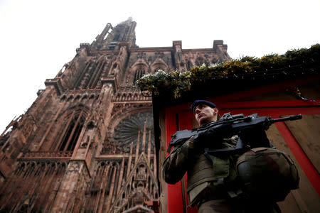 A French soldier stands guard near a closed wooden barrack shop at the traditional Christkindelsmaerik (Christ Child market) in front of the Cathedral the day after a shooting in Strasbourg, France, December 12, 2018. REUTERS/Christian Hartmann TPX IMAGES OF THE DAY