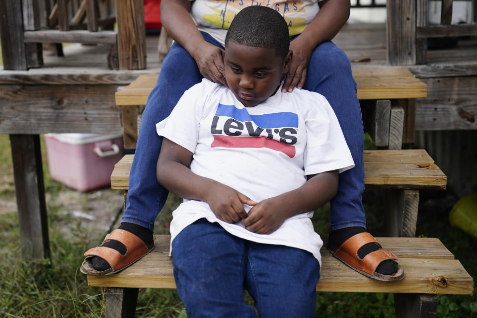 Yuri Brown, 7, sits with his mother, Bontressa Brown, for a portrait outside their home on Tuesday, Nov. 14, 2023, in Sylvester, Ga. Bontressa was seven months pregnant with Yuri when Terrell “Al” Clark died after an encounter with police in Sylvester. Clark was Yuri’s father. (AP Photo/Brynn Anderson)