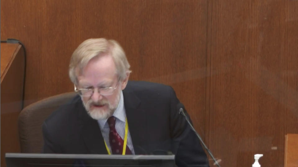 In this image from video, Dr. Martin Tobin regards the screen in front on him as he testifies Thursday, April 8, 2021, in the trial of former Minneapolis police Officer Derek Chauvin at the Hennepin County Courthouse in Minneapolis, Minn. Chauvin is charged in the May 25, 2020 death of George Floyd. (Court TV via AP, Pool)