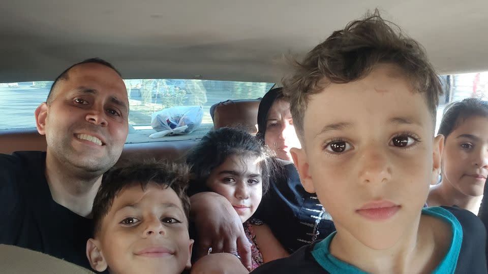 Writer Hani Almadhoun with his family in Gaza, during a visit over summer. His nephews Omar (next to Hani) and Ali (closest to camera) were among those who died in an Israeli airstrike last week. - Hani Almadhoun