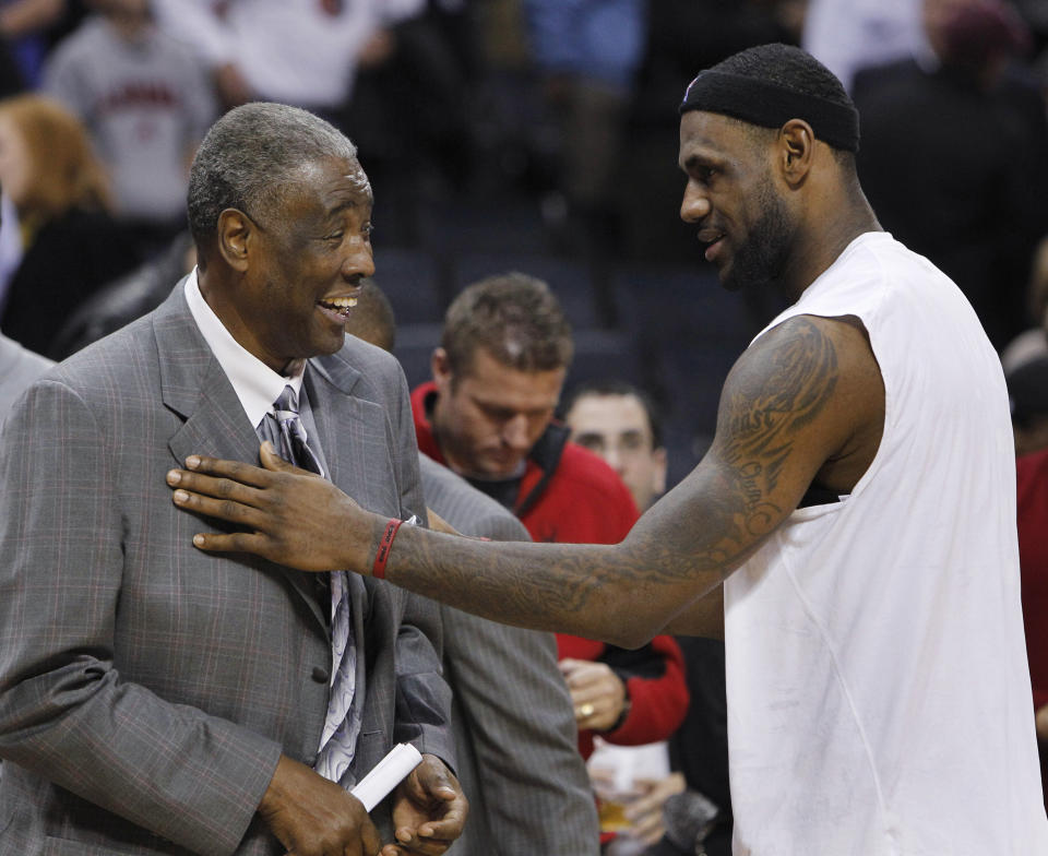 Miami Heat's LeBron James, right, jokes with Charlotte Bobcats coach Paul Silas, left, after the Heat's 96-82 win in an NBA basketball game in Charlotte, N.C., Monday, Jan. 3, 2011. (AP Photo/Chuck Burton)