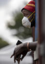 A man wearing a face mask to protect against coronavirus, watches the South African National Defence Forces raids a hostel in densely populated Alexandra township east of Johannesburg, South Africa, Saturday, March 28, 2020. South Africa went into a nationwide lockdown for 21 days in an effort to mitigate the spread to the coronavirus.The new coronavirus causes mild or moderate symptoms for most people, but for some, especially older adults and people with existing health problems, it can cause more severe illness or death. (AP Photo/Themba Hadebe)