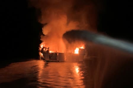 Ventura County Fire Department personnel respond to a boat fire off Santa Cruz Island