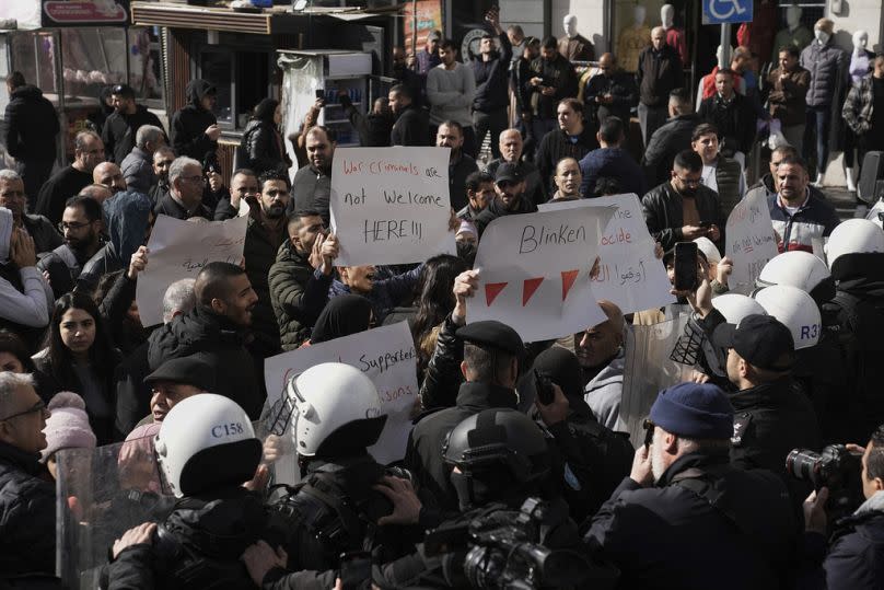 Riot police officers stand guard while Palestinians protest against the visit of U.S. Secretary of State Antony Blinken and his meeting with Palestinian President.