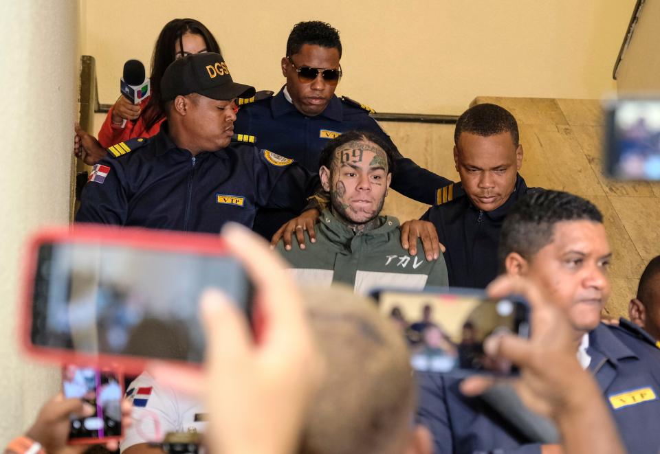 Rapper Daniel Hernandez, known as Tekashi 6ix9ine, is escorted by police as he arrives to appear at court, Palace of Justice, in Santo Domingo, Dominican Republic, Thursday, Jan. 25, 2024. Authorities arrested the rapper on Jan. 17 on charges of domestic violence.