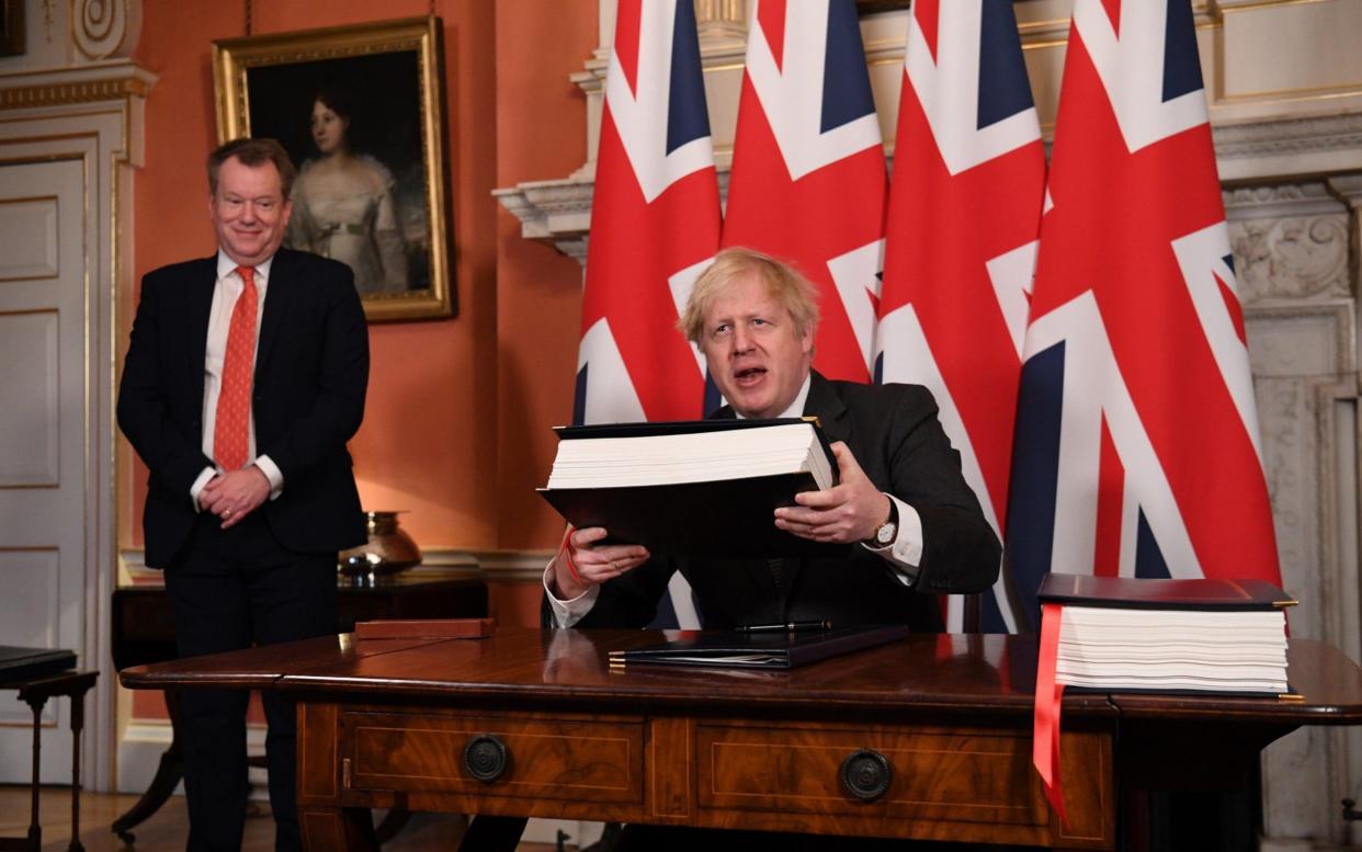 UK chief trade negotiator, David Frost looks on as Prime Minister, Boris Johnson signs the Brexit trade deal with the EU - Leon Neal/Getty Images Europe 