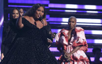 Lizzo accepts the award for best pop solo performance for "Truth Hurts" at the 62nd annual Grammy Awards on Sunday, Jan. 26, 2020, in Los Angeles. Looking on at right is Cynthia Erivo. (Photo by Matt Sayles/Invision/AP)