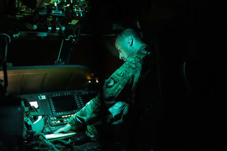 Pilot Joseph Swift prepares for a night flight on an HH-60 Blackhawk helicopter from 101st Airborne Division's "Dustoff" unit during recovery efforts following Hurricane Maria, in Arecibo, Puerto Rico, October 5, 2017. REUTERS/Lucas Jackson