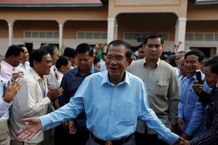 Cambodia's Prime Minister and President of the Cambodian People's Party (CPP), Hun Sen is surrounded by his commune counselors during a senate election in Takhmao, Kandal province, Cambodia February 25, 2018. REUTERS/Samrang Pring