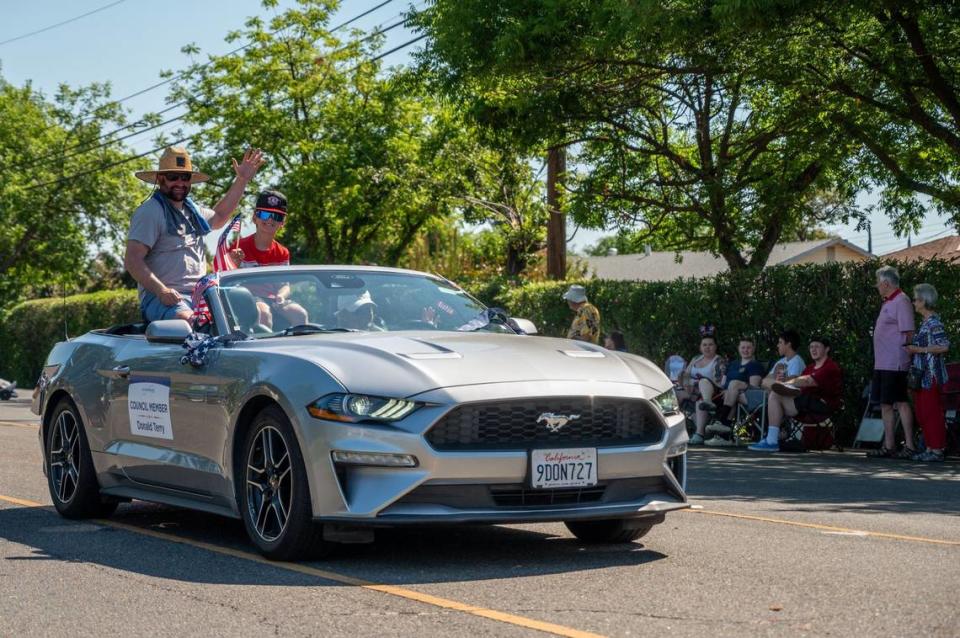 Rancho Cordova Councilman Donald Terry and son Holden Terry ride a silver Mustang down Coloma Road in the city’s Fourth of July parade on Thursday.