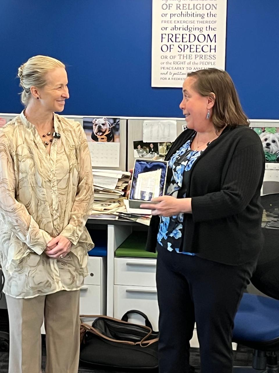Leanne Graham, president and CEO of Summit County's Victim Assistance Program, presents Beacon Journal reporter Stephanie Warsmith with this year's Rev. Dr. Robert A. Denton Outstanding Victim Services Award.