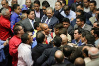 Deputies of the Venezuelan coalition of opposition parties (MUD) and of the Venezuela's United Socialist Party (PSUV) scuffle during a session of the National Assembly in Caracas, Venezuela October 25, 2016. REUTERS/Marco Bello