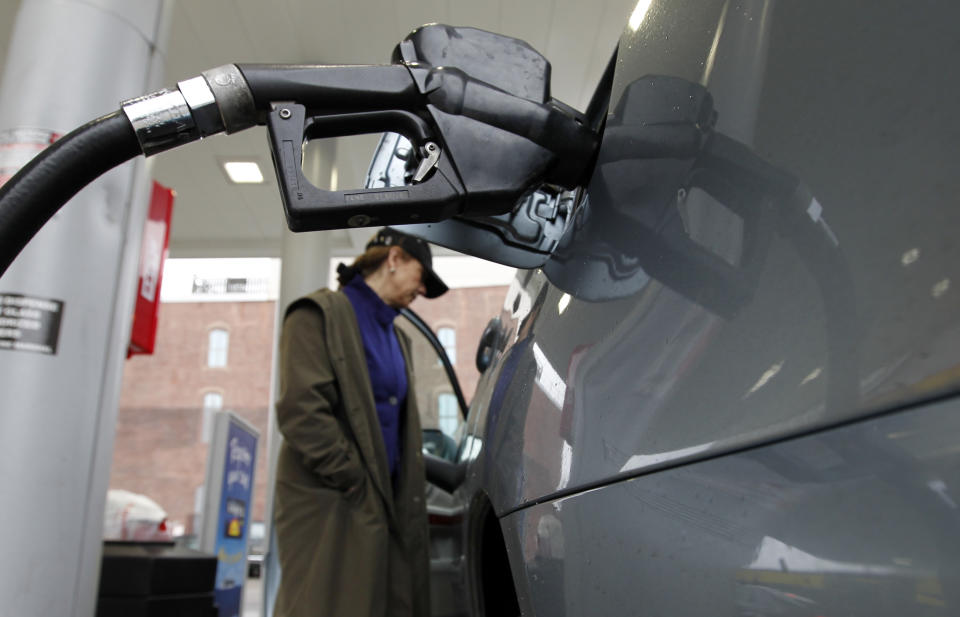 Deborah Delauro waits as she puts gas in her car Friday, Feb. 24, 2012 in Philadelphia. The price of gasoline, which is made from crude oil, has soared as oil prices rise. The national average jumped by nearly 12 cents per gallon in a week, with state averages above $4 per gallon in California, Alaska and Hawaii. (AP Photo/Alex Brandon)